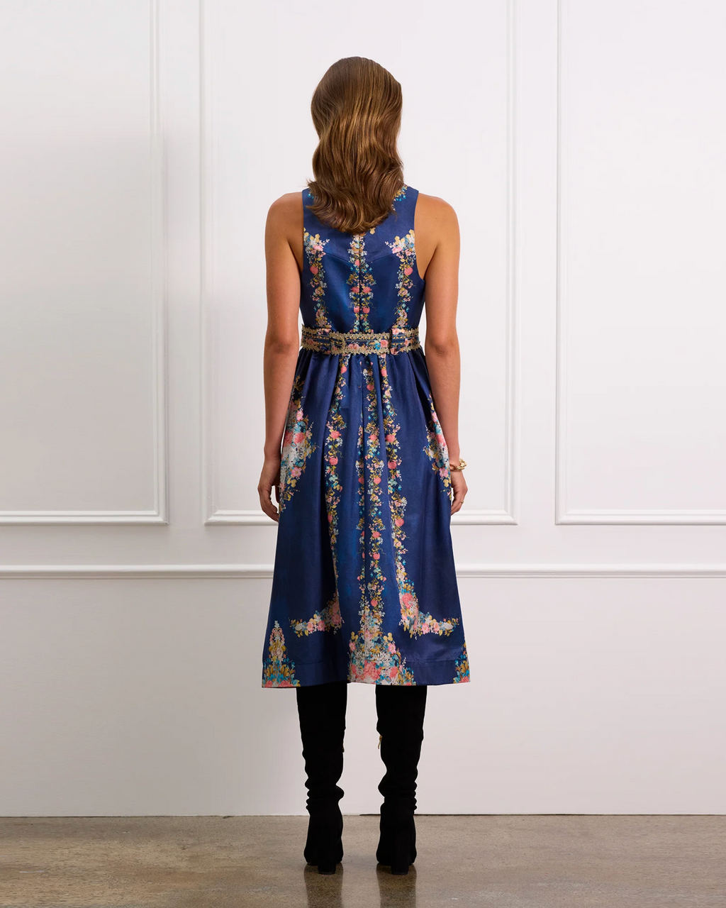 Woman wearing a blue floral dress with a white background